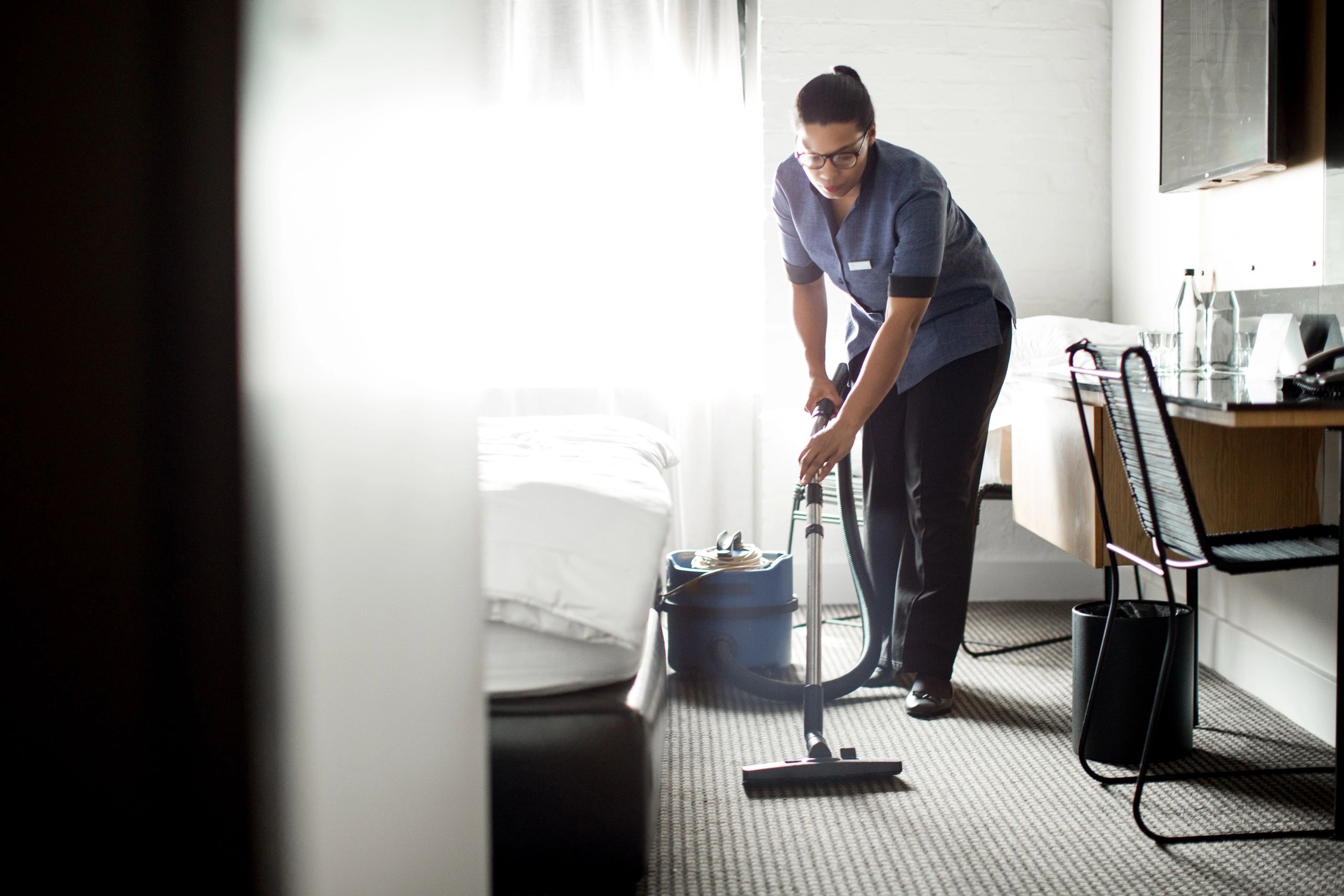 Cleaning professional vacuuming an interior space